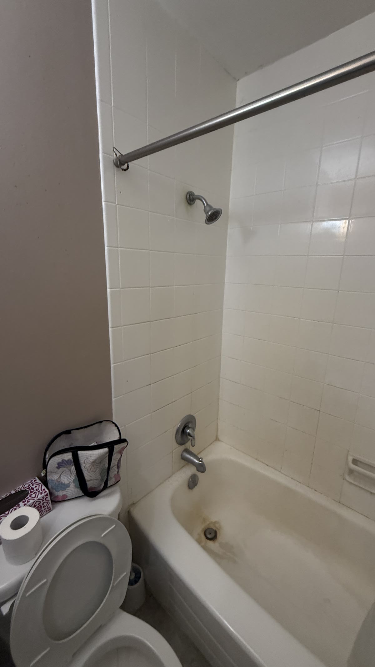 Original bathtub and tile before a bathroom renovation in New Westminster BC