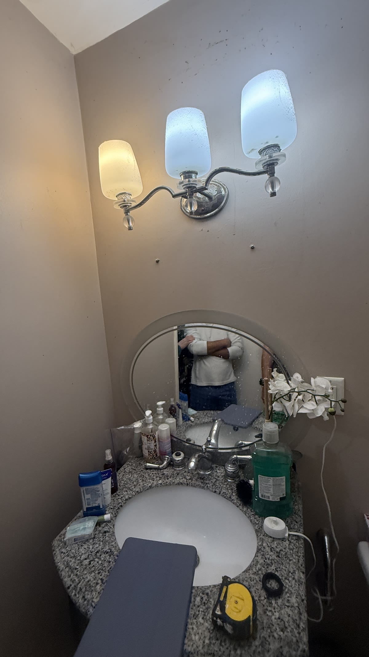 Original vanity mirror and lighting before bathroom renovation