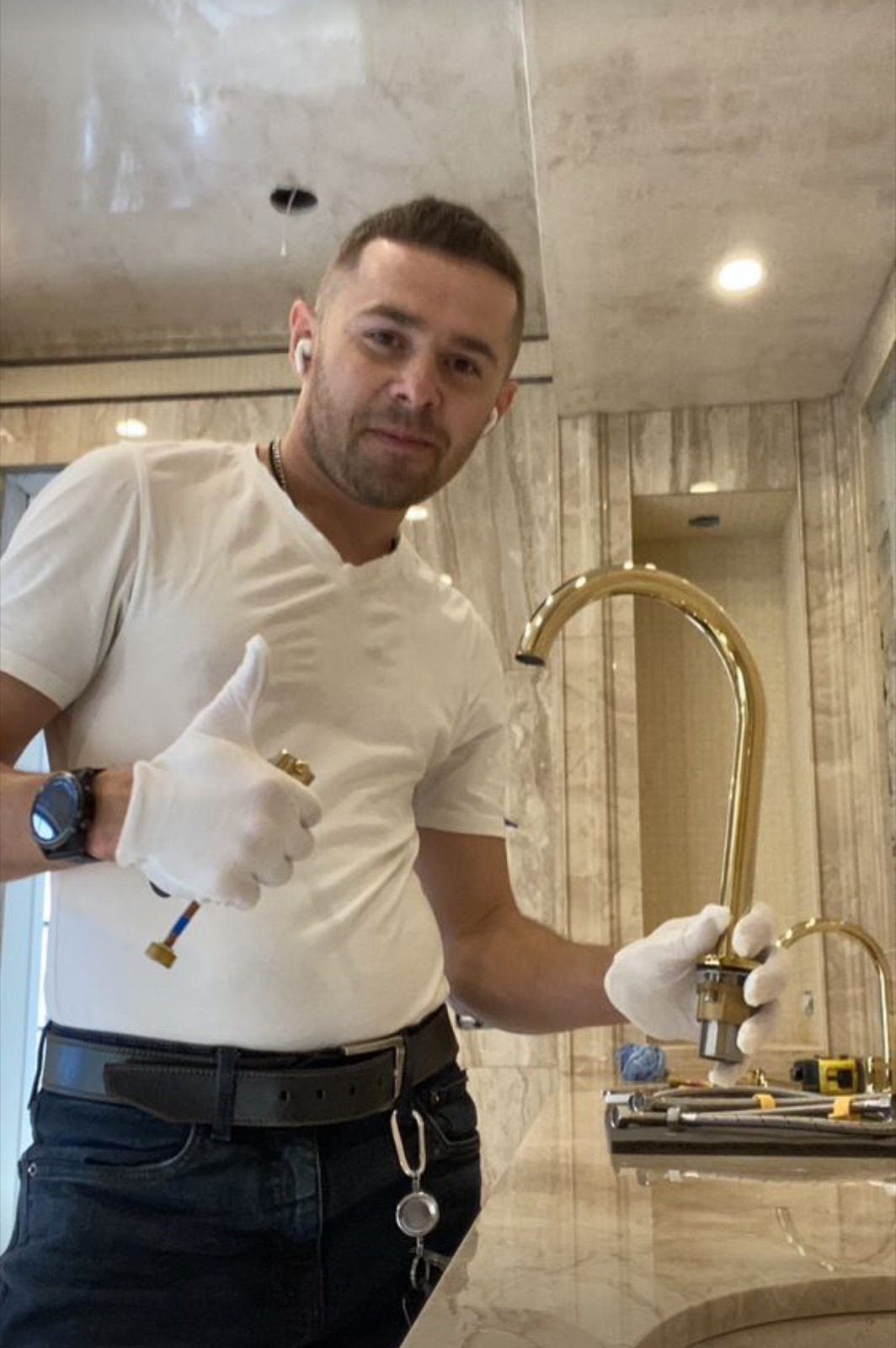 Alex installing a kitchen faucet during a Budova handyman project