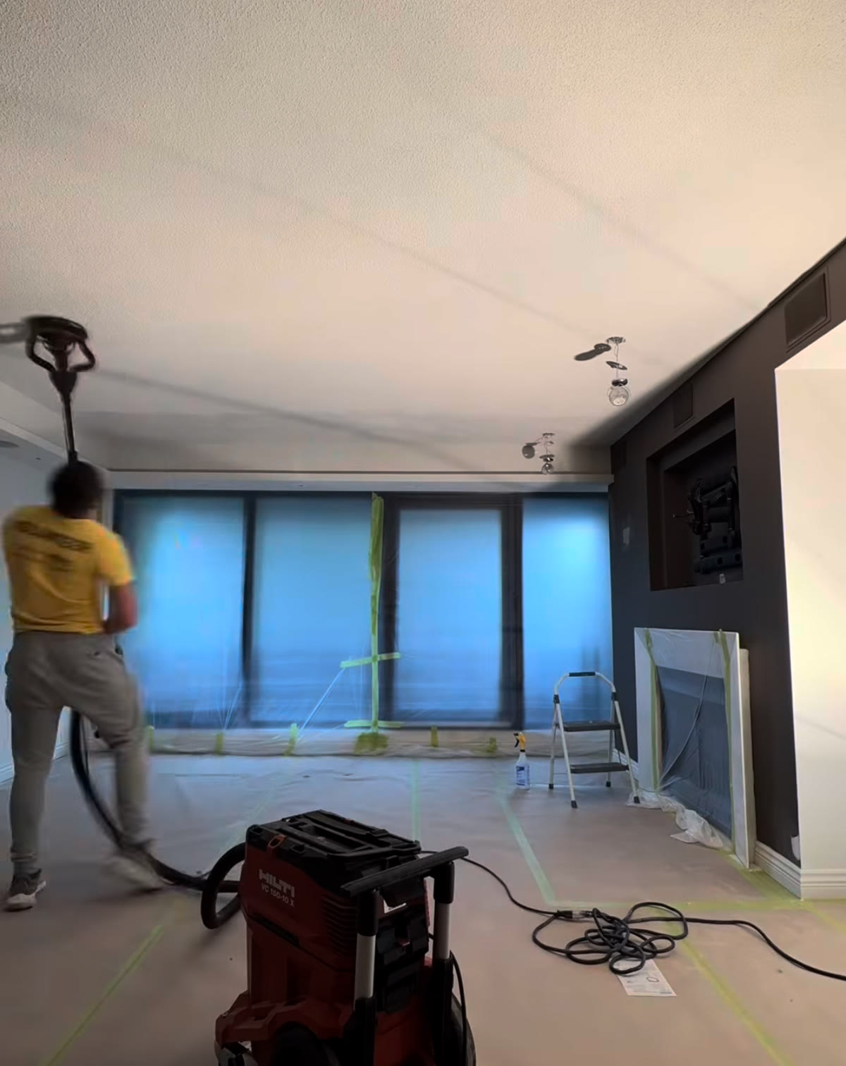 Budova removing a popcorn ceiling with dust extraction and the room fully protected
