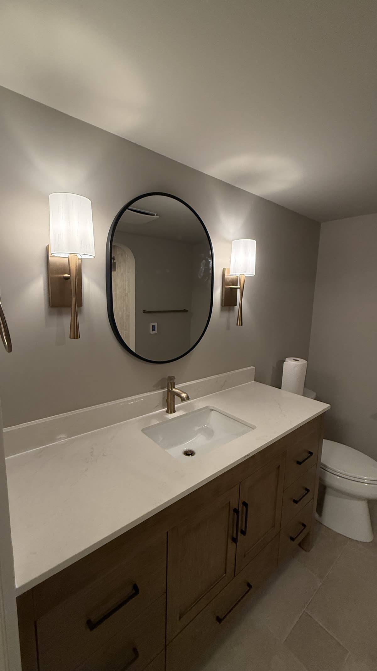 New vanity countertop mirror and lighting in a Vancouver bathroom